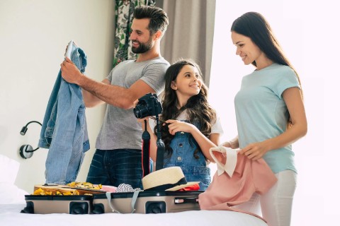 Family happily planning vacation on laptop