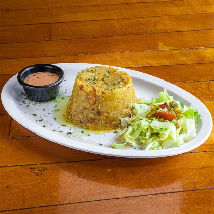 Colorful Dominican meal with plantains and seafood